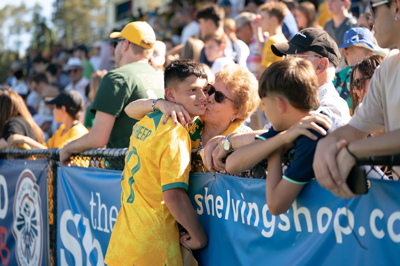 Kaylan van Heer is kissed by a family member after making his Pararoos debut against USA, in February 2023.